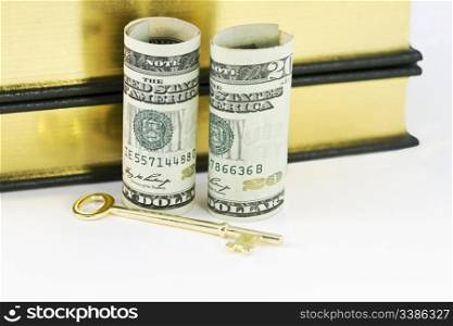 Dollar currency placed with gold key symbolizes critical role of cash reserves for banks, industry, investors, and governments
