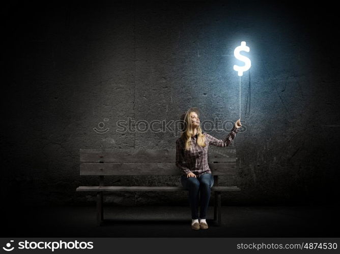 Dollar currency. Young woman holding balloon shaped like dollar sign