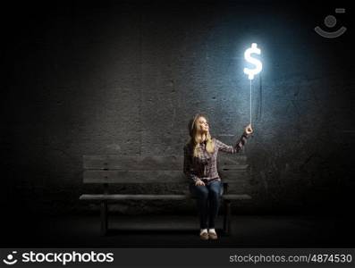 Dollar currency. Young woman holding balloon shaped like dollar sign