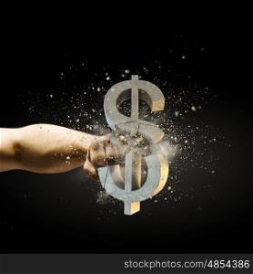 Dollar failure. Close up image of human hand breaking dollar stone symbol