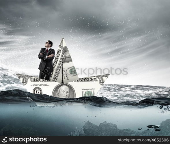 Dollar paper boat. Businessman in ship of dollar banknote floating on water