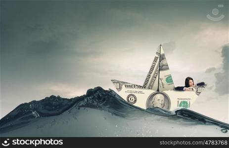Dollar paper boat. Businesswoman in ship of dollar banknote floating on water