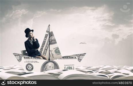 Dollar paper boat. Businesswoman in ship of dollar banknote floating on water