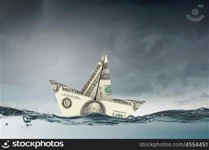 Dollar paper boat. Ship of dollar banknote floating on water