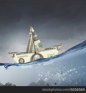 Dollar paper boat. Ship of dollar banknote floating on water