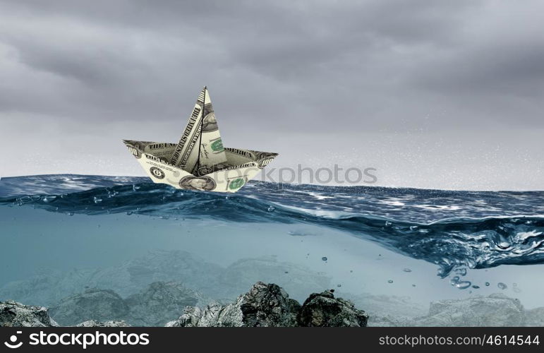 Dollar ship in water. Ship made of dollar banknote floating in water