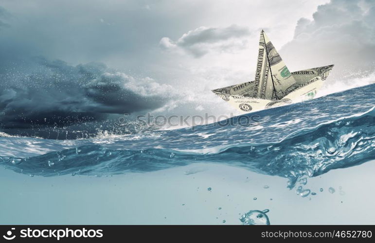 Dollar ship in water. Ship made of dollar banknote floating in water