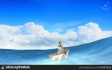 Dollar ship in water. Ship made of dollar banknote floating in water