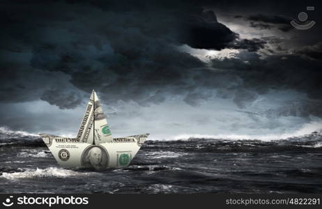 Dollar ship in water. Ship made of dollar banknote floating in water