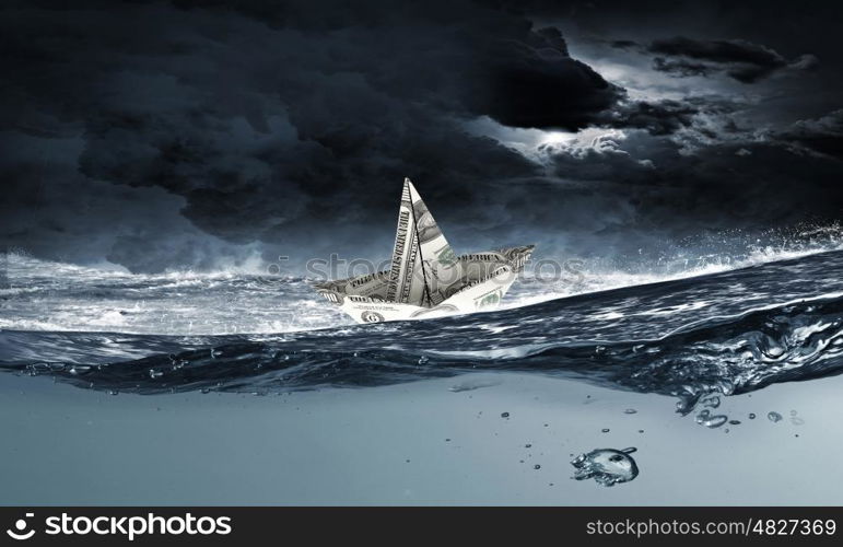 Dollar ship in water. Ship made of dollar banknote floating in water