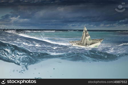 Dollar ship in water. Ship made of dollar banknote floating in water