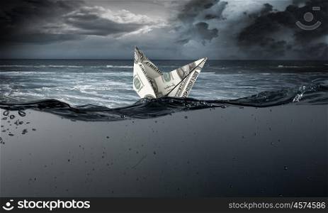 Dollar ship in water. Ship made of dollar banknote sinking in water