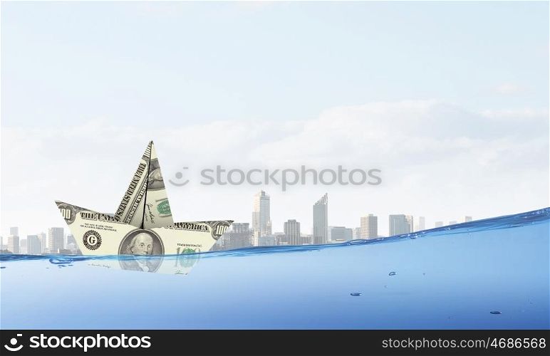 Dollar ship. Ship made of dollar banknote floating in water