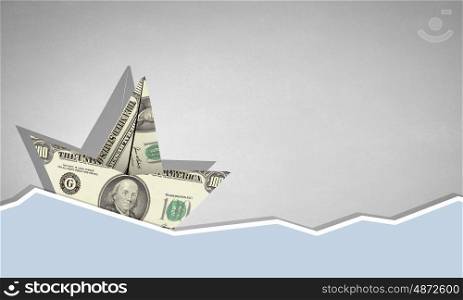 Dollar ship. Ship made of dollar banknote floating in water