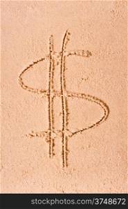 Dollar symbol drawn on wet sand on the beach