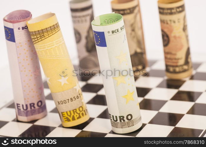 Dollars and Euro banknotes on chess board