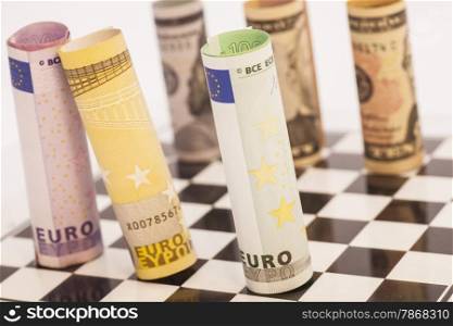 Dollars and Euro banknotes on chess board