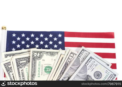 Dollars bills on American flag isolated on white