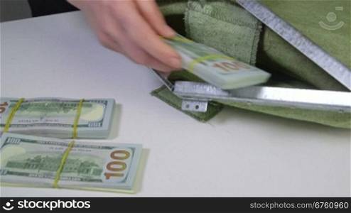 Dollars packs folded in cash collection bag and sealed