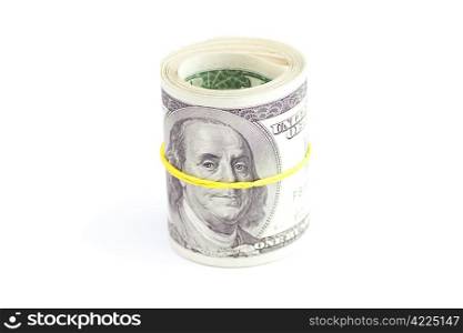Dollars rolled into a tube tied with an elastic band isolated on white