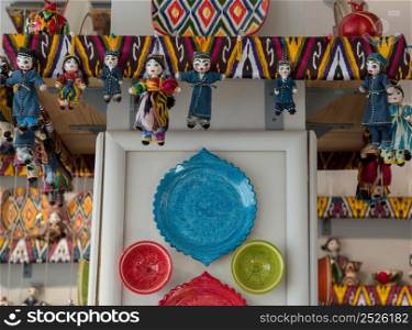 dolls and dishes in traditional Oriental ornaments. national uzbek souvenirs. bright Oriental Souvenirs