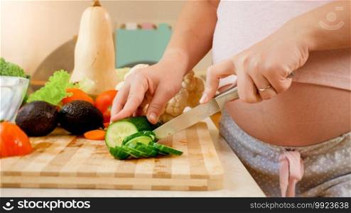 Dolly video of pregnant woman waiting for baby cooking healthy vegetable salad on kitchen. Concept of healthy lifestyle and nutrition during pregnancy.. Dolly video of pregnant woman waiting for baby cooking healthy vegetable salad on kitchen. Concept of healthy lifestyle and nutrition during pregnancy