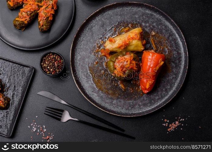 Dolma, stuffed grape leaves with rice and meat on a dark background. Caucasian and Turkish cuisine. Dolma, stuffed grape leaves with rice and meat on a dark background