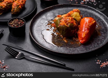 Dolma, stuffed grape leaves with rice and meat on a dark background. Caucasian and Turkish cuisine. Dolma, stuffed grape leaves with rice and meat on a dark background