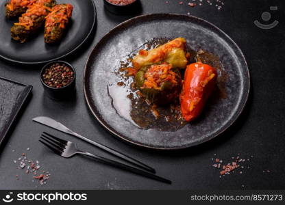 Dolma, stuffed grape leaves with rice and meat on a dark background. Caucasian and Turkish cuisine. Dolma, stuffed grape leaves with rice and meat on a dark background