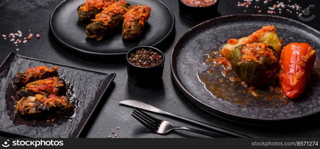 Dolma, stuffed grape leaves with rice and meat on a dark background. Caucasian and Turkish cuisine. Dolma, stuffed grape leaves with rice and meat on a dark background