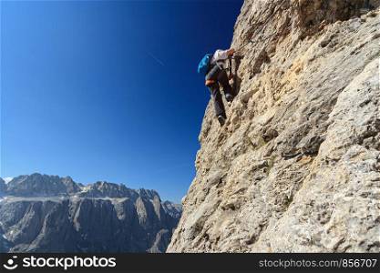 Dolomiti - Female climber on Cir V Via Ferrata. woman on via ferrata