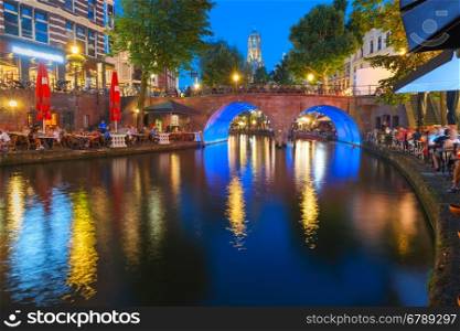 Dom Tower and canal Oudegracht in the night colorful illuminations in the blue hour, Utrecht, Netherlands