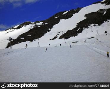 Dombay mountains wintertime. Skiers on the track