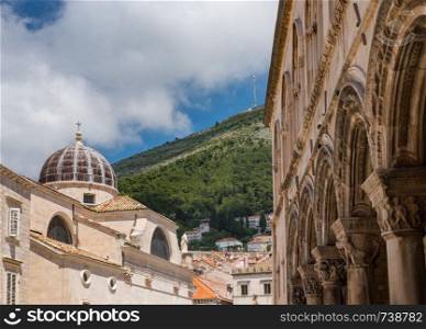 Dome on St Blaise church with Rector's palace entrance in the old town of Dubrovnik in Croatia. Details of roof of St Blaise church in Dubrovnik old town