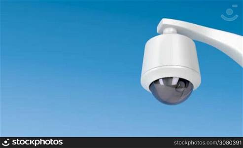 Dome security camera against blue sky