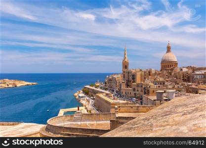 Domes and roofs of Valletta , Malta. View from above of the domes of churches and roofs with church of Our Lady of Mount Carmel and St. Paul's Anglican Pro-Cathedral, Valletta, Capital city of Malta
