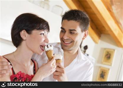 domestic life: happy couple eating an ice cream