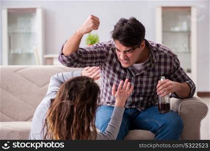 Domestic violence concept in a family argument with drunk alcoho. Domestic violence concept in a family argument with drunk alcoholic husband