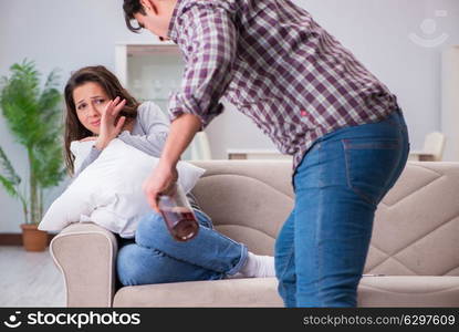 Domestic violence concept in a family argument with drunk alcoho. Domestic violence concept in a family argument with drunk alcoholic husband