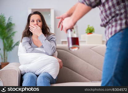 Domestic violence concept in a family argument with drunk alcoho. Domestic violence concept in a family argument with drunk alcoholic husband