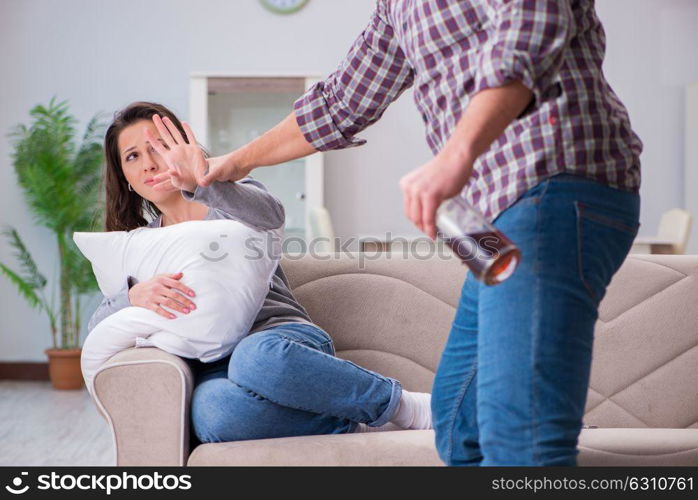 Domestic violence concept in a family argument with drunk alcoho. Domestic violence concept in a family argument with drunk alcoholic husband