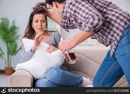 Domestic violence concept in a family argument with drunk alcoho. Domestic violence concept in a family argument with drunk alcoholic husband