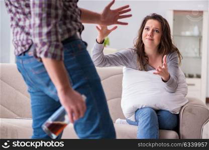 Domestic violence concept in a family argument with drunk alcoho. Domestic violence concept in a family argument with drunk alcoholic husband