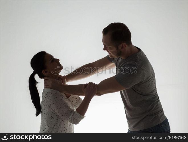 domestic violence, people and abuse concept - couple having fight and man choking woman. couple having fight and man choking woman