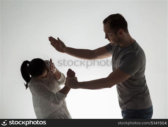domestic violence, people and abuse concept - couple having fight and man slapping woman. couple having fight and man slapping woman