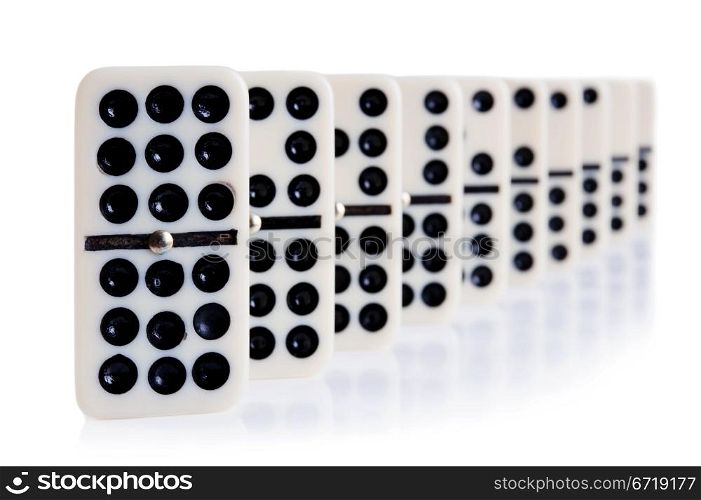 domino in row on white with light reflection on the background