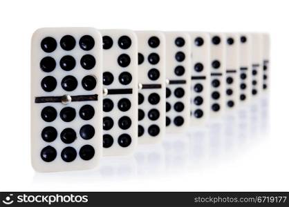 domino in row on white with light reflection on the background