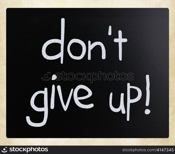""Don&rsquo;t give up" handwritten with white chalk on a blackboard"