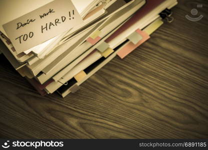 Don&rsquo;t Work Too Hard; The Pile of Business Documents on the Desk