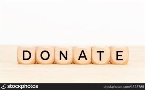 Donation word on wooden block shape. Copy space. White background
